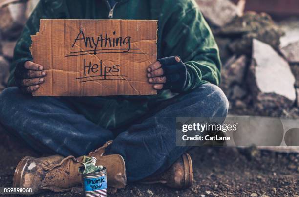 fighting adversity. homeless man with sign and money tin - beggar stock pictures, royalty-free photos & images