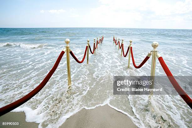 red velvet ropes leading to ocean - the shallows world premiere stock pictures, royalty-free photos & images