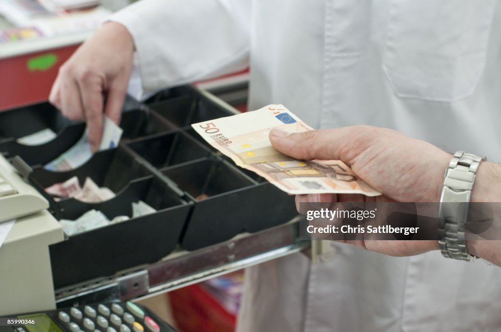 Cash in hand of customer paying in supermarket