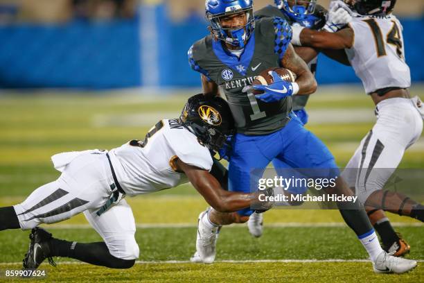 Lynn Bowden Jr. #1 of the Kentucky Wildcats runs the ball as Thomas Wilson of the Missouri Tigers tries to make the stop at Commonwealth Stadium on...