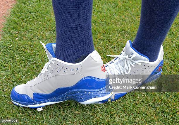 Curtis Granderson of the Detroit Tigers shows off special spikes he's wearing to honor Jackie Robinson against the Chicago White Sox during the...
