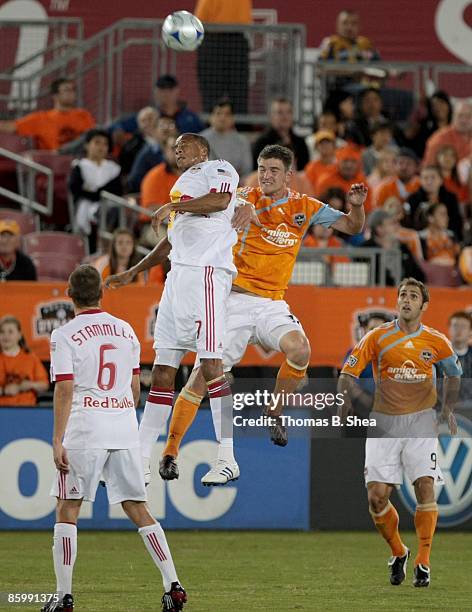 Bobby Boswell of the Houston Dynamo fights for a header against Khano Smith of the New York Red Bulls on April 11, 2009 at Robertson Stadium in...