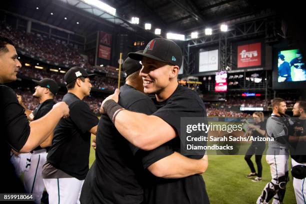 Jake Lamb of the Arizona Diamondbacks celebrates with teammates after defeating the Colorado Rockies in the National League Wild Card Game at Chase...