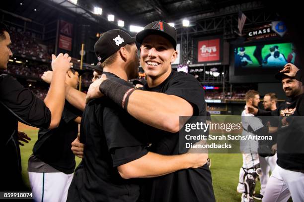 Jake Lamb of the Arizona Diamondbacks celebrates with teammates after defeating the Colorado Rockies in the National League Wild Card Game at Chase...