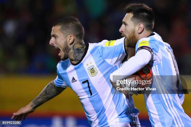 Lionel Messi of Argentina celebrates with teammate Dario Benedetto after scoring the first goal of his team during a match between Ecuador and...