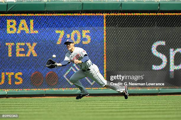 Grady Sizemore of the Cleveland Indians, wearing a jersey during the Jackie Robinson Day game dives to make a catch on Alex Gordon of the Kansas City...