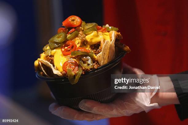 Worker prepares nachos for a customer before the Opening Day game between the Milwaukee Brewers and the Chicago Cubs on April 10, 2009 at Miller Park...
