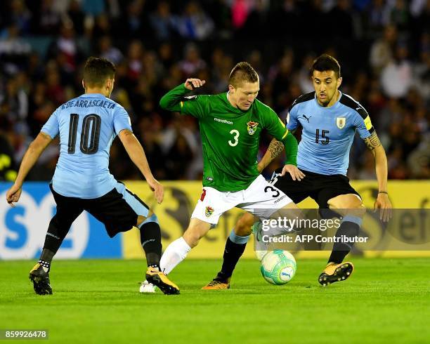 Bolivia's Alejandro Chumacero vies for the ball with Uruguay's Matias Vecino and Giorgian De Arrascaeta during their 2018 World Cup football...