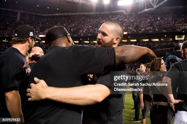 Robbie Ray of the Arizona Diamondbacks hugs Fernando Rodney after defeating the Colorado Rockies in the National League Wild Card Game at Chase Field...