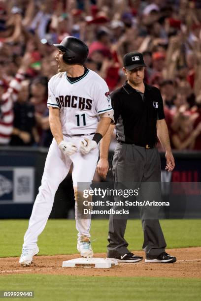 Pollock of the Arizona Diamondbacks reacts after hitting an RBI triple during the National League Wild Card Game against the Colorado Rockies at...