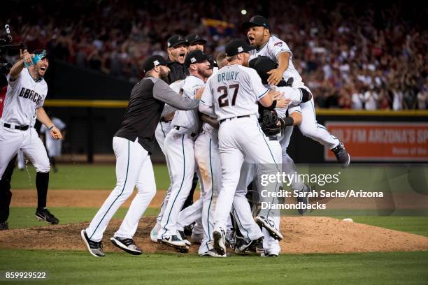 The Arizona Diamondbacks celebrate after defeating the Colorado Rockies in the National League Wild Card Game at Chase Field on October 4, 2017 in...