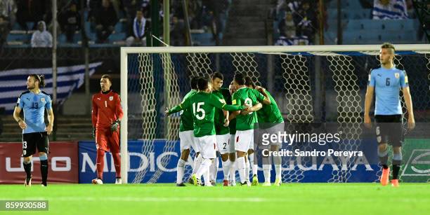 Players of Bolivia celebrate an own goal scored by Gaston Silva of Uruguay during a match between Uruguay and Bolivia as part of FIFA 2018 World Cup...