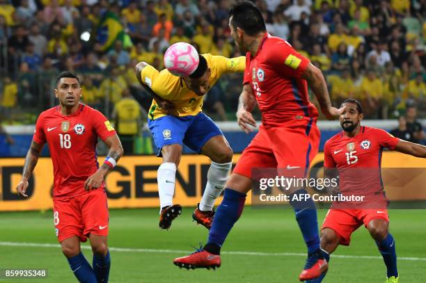 Brazil's Gabriel Jesus heads the ball as Chile's Gonzalo Jara , Gary Medel and Jean Beausejour look on during their 2018 World Cup football qualifier...