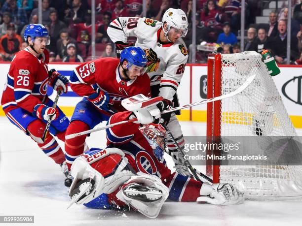 Goaltender Carey Price of the Montreal Canadiens covers the puck with his glove while teammate Victor Mete defends against Brandon Saad of the...