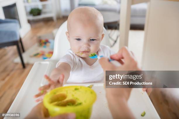 point of view of mom feeding her baby with a spoon - spoon feeding stock pictures, royalty-free photos & images