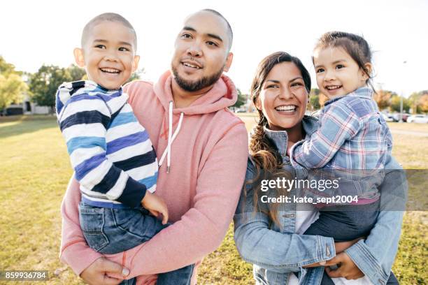 glückliche familie  - asian family in park stock-fotos und bilder