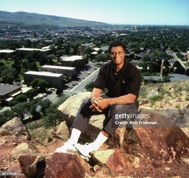 Portrait of Idaho State athletic director Irv Cross sitting on rocks at The Pillars. Cross was the first black sports analyst on national television....