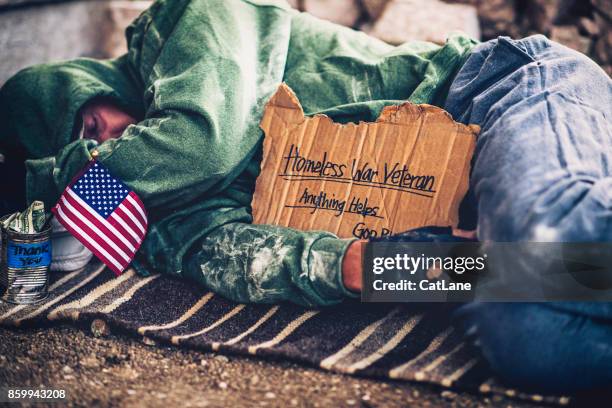 fighting adversity. homeless war veteran sleeping with sign and money tin - military bowl stock pictures, royalty-free photos & images