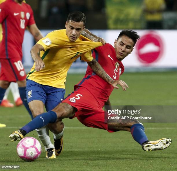 Brazil's Philippe Coutinho and Chile's Erick Pulgar vie for the ball during their FIFA 2018 World Cup qualifier football match in Sao Paulo, Brazil,...