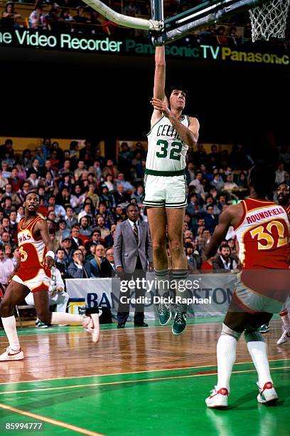 Kevin McHale of the Boston Celtics shoots a hook shot against Dan Roundfield of the Atlanta Hawks during a game played in 1983 at the Boston Garden...