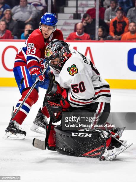 Goaltender Corey Crawford of the Chicago Blackhawks makes a save near Ales Hemsky of the Montreal Canadiens during the NHL game at the Bell Centre on...