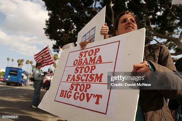 Demonstrators gather at an American Family Association -sponsored T.E.A. Party to protest taxes and economic stimulus spending on the last day to...