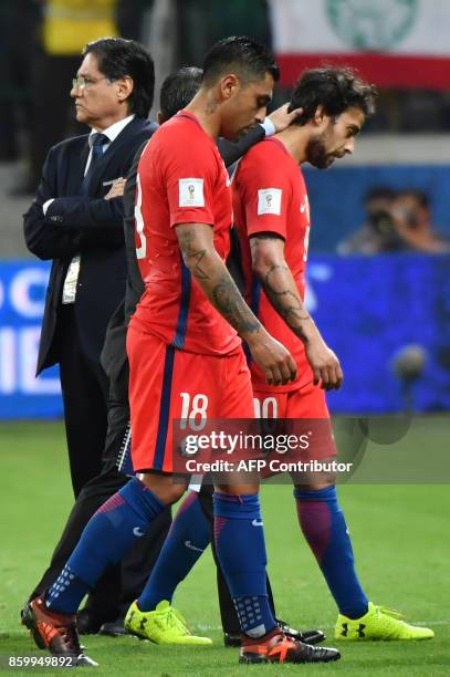 Chile's Gonzalo Jara and Jorge Valdivia show their dejection after being defeated by Brazil in a qualifier match and missing the 2018 World Cup...