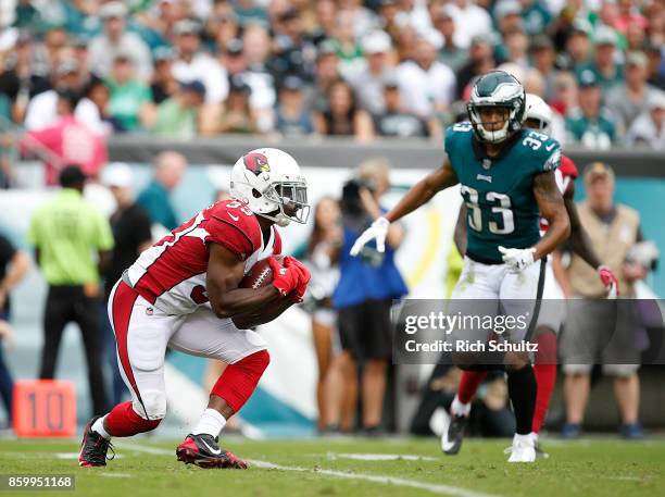 Kerwynn Williams of the Arizona Cardinals catches a kick as Dexter McDougle of the Philadelphia Eagle closes in during the third quarter of a game at...