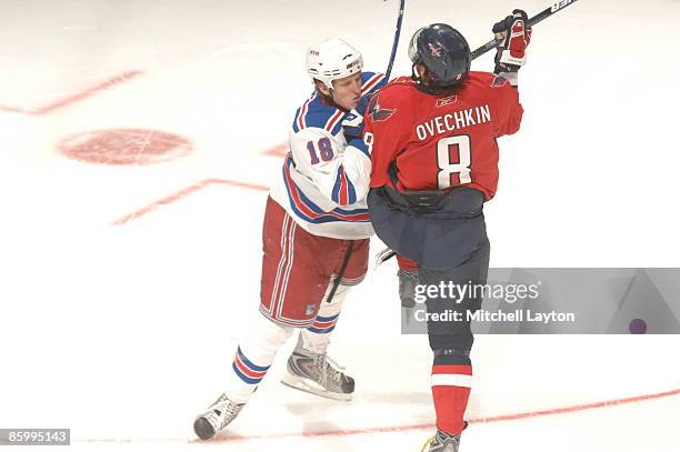 Marc Staal of the New York Rangers checks Alex Ovechkin of the Washington Capitals during Game One of the Eastern Conference Quarterfinals of the...