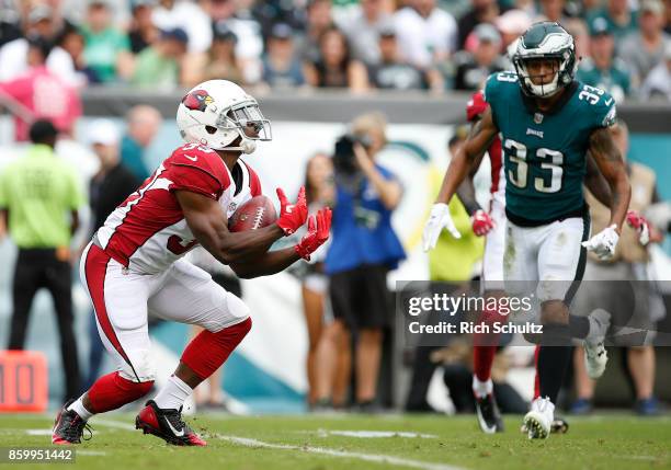 Kerwynn Williams of the Arizona Cardinals catches a kick as Dexter McDougle of the Philadelphia Eagle closes in during the third quarter of a game at...