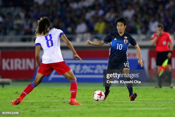 Shinji Kagawa of Japan takes on Zachary Herivaux of Haiti during the international friendly match between Japan and Haiti at Nissan Stadium on...