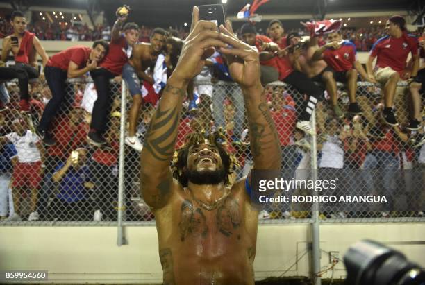 Panama's Roman Torres takes a picture of his team's fans celebrating after he scored against Costa Rica during their 2018 World Cup qualifier...