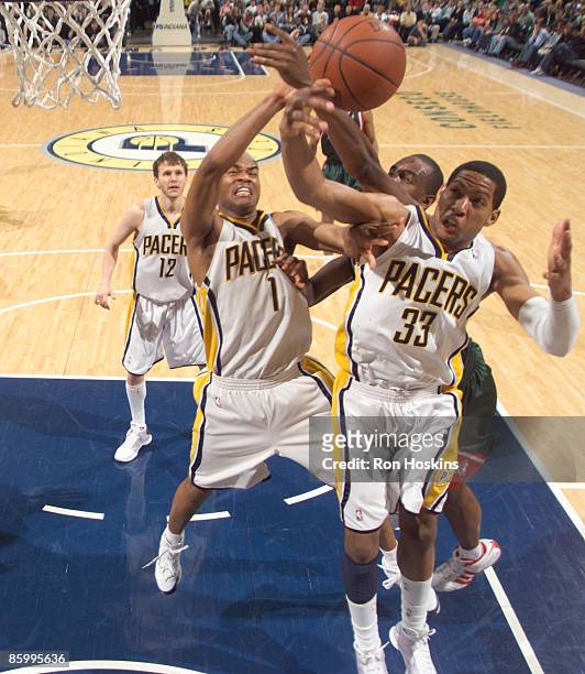 Danny Granger and Jarrett Jack of the Indiana Pacers battle a Milwaukee Bucks defender at Conseco Fieldhouse on April 15, 2009 in Indianapolis,...