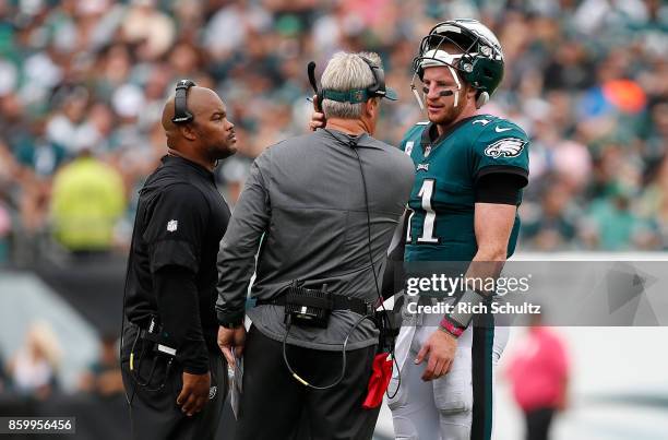 Quarterback Carson Wentz of the Philadelphia Eagles talks with head coach head coach Doug Pederson and Assistant Coach Duce Staley during the second...