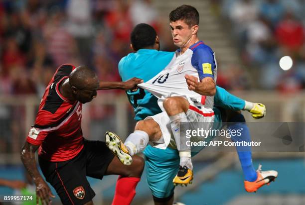 Trinidad and Tobago's Daneil Cyrus and USA's Christian Pulisic vie during their 2018 World Cup qualifier football match in Couva, Trinidad and...