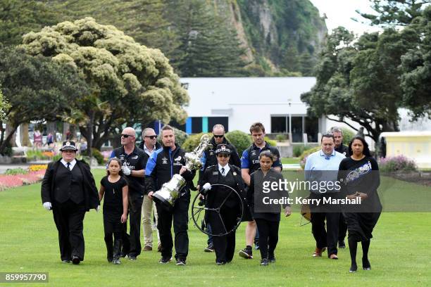 Steve Collie carries the America's Cup along the Marine Parade before the civic reception during the America's Cup Regional Tour on October 11, 2017...