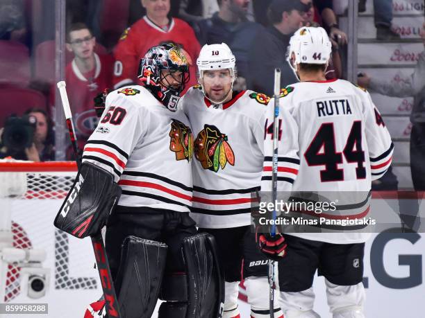 Goaltender Corey Crawford of the Chicago Blackhawks celebrates a victory with teammates Patrick Sharp and Jan Rutta against the Montreal Canadiens...