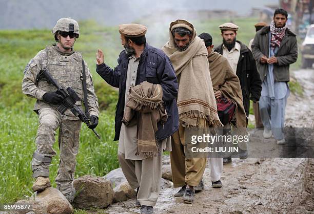 Afghanistan-unrest-military, FOCUS by Charlotte McDonald-Gibson A US soldier from 1st Infantry Division is greeted by an Afghan man during a patrol...