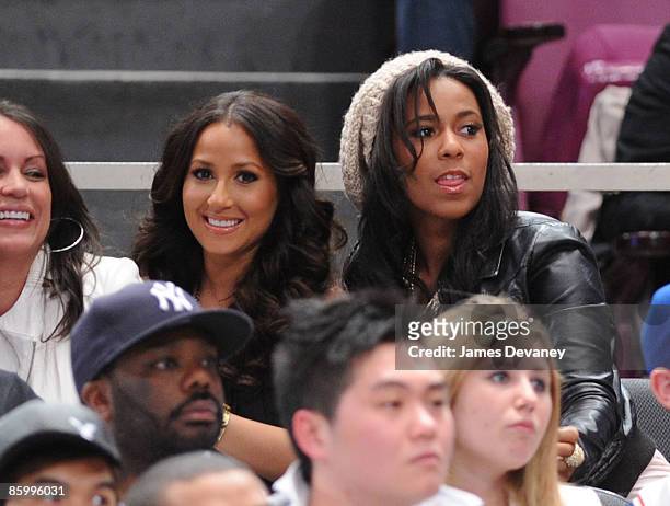 Adrienne Bailon and guest attend New Jersey Nets vs New York Knicks game at Madison Square Garden on April 15, 2009 in New York City.