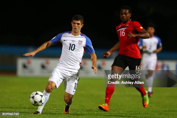 Christian Pulisic of the United States mens national team runs with the ball as Levi Garcia of Trinidad and Tobago chases him down during the FIFA...