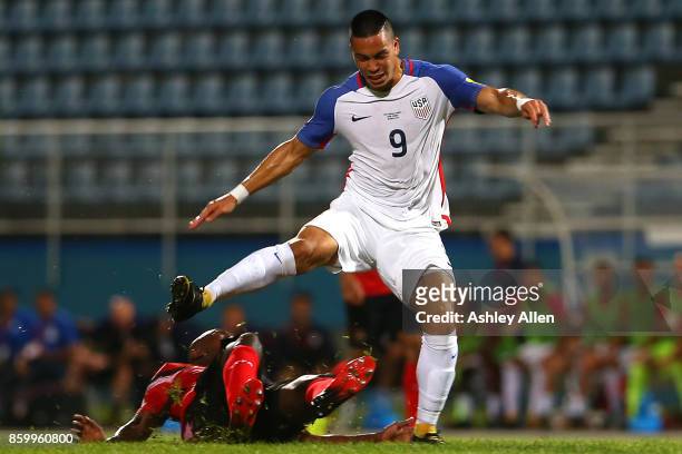 Bobby Wood of the United States mens national team is tackled by Khaleem Hyland of Trinidad and Tobago during the FIFA World Cup Qualifier match...