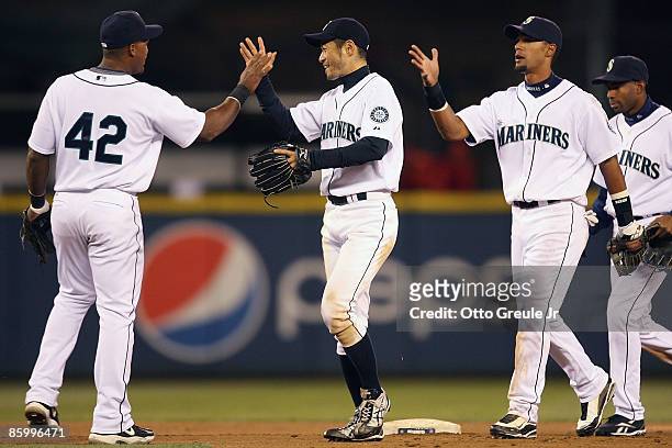 Adrian Beltre, Ichiro Suzuki and Franklin Gutierrez of the Seattle Mariners celebrate after defeating the Los Angeles Angels of Anaheim 11-3 at...