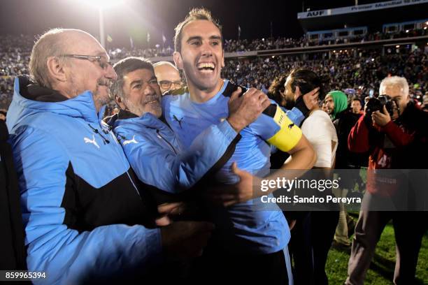 Diego Godin captain of Uruguay , doctor Alberto Pan and physical trainer Jose Herrera celebrate the victory and qualifying to the World Cup after a...