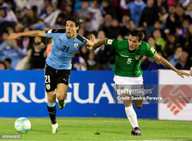 Edinson Cavani of Uruguay and Gabriel Valverde of Bolivia fight for the ball during a match between Uruguay and Bolivia as part of FIFA 2018 World...