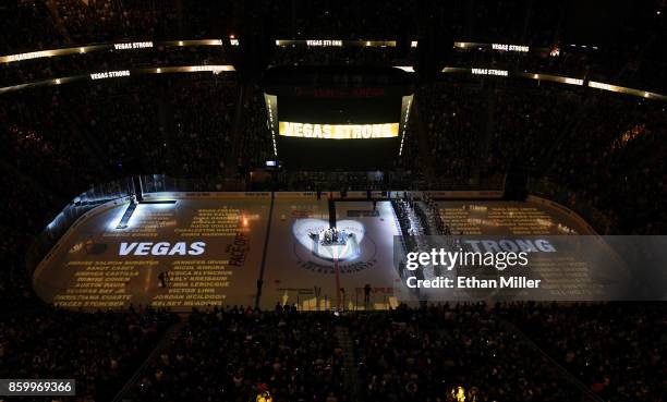 The names of the 58 people killed at the Route 91 Harvest country music festival are projected on the ice before the Vegas Golden Knights' inaugural...