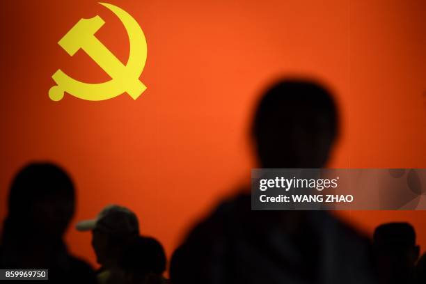 This picture taken on October 10, 2017 shows a party flag of the Chinese Communist Party displayed at an exhibition showcasing China's progress in...