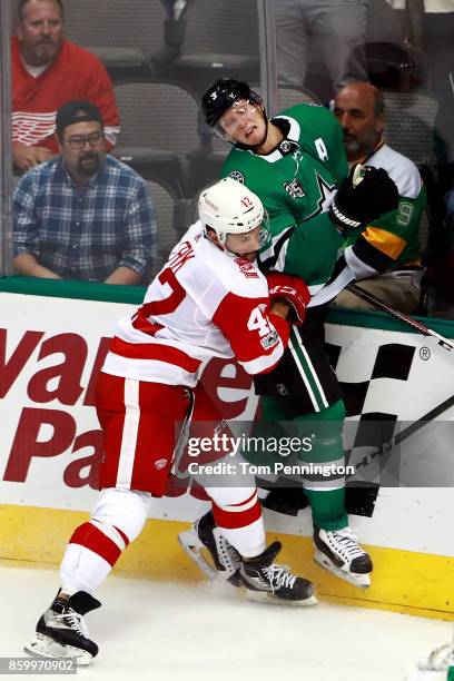 Martin Frk of the Detroit Red Wings checks John Klingberg of the Dallas Stars into the glass in the third period at American Airlines Center on...