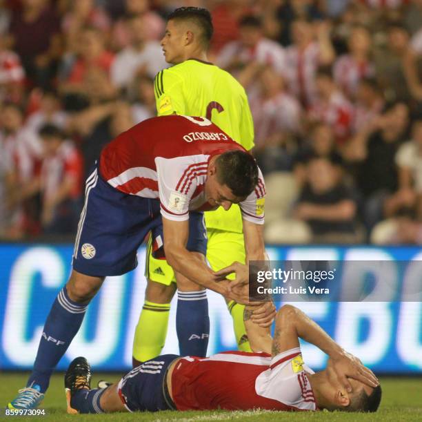 Oscar Cardozo of Paraguay helps teammate Gustavo Gomez during a match between Paraguay and Venezuela as part of FIFA 2018 World Cup Qualifiers at...