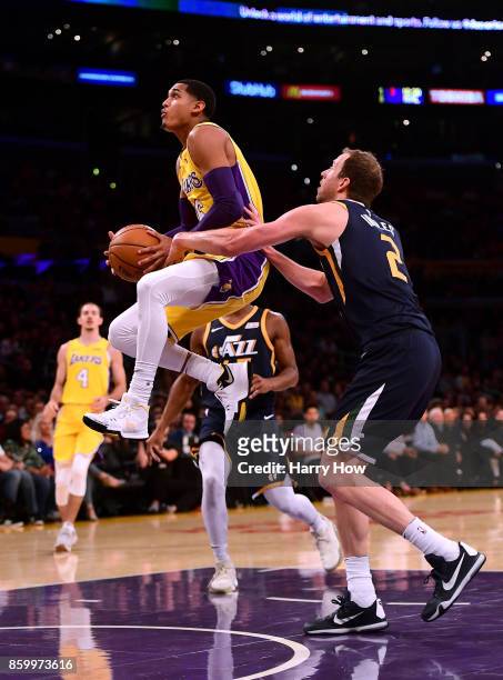 Jordan Clarkson of the Los Angeles Lakers gets fouled by Joe Ingles of the Utah Jazz as he jumps to the basket during the first half at Staples...