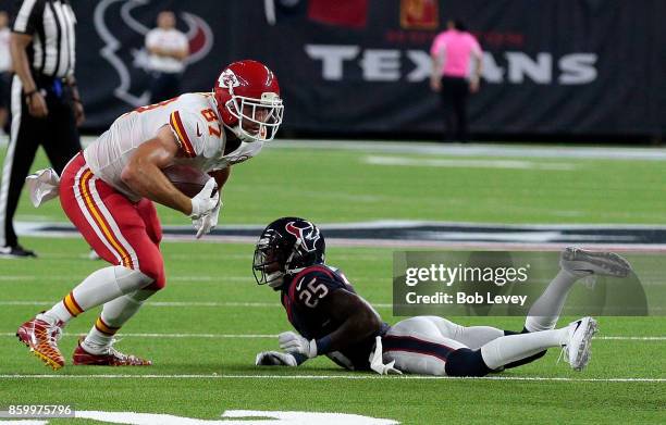 Travis Kelce of the Kansas City Chiefs looks to run after a receptions as he shakes the tackle attempt of Kareem Jackson of the Houston Texans at NRG...